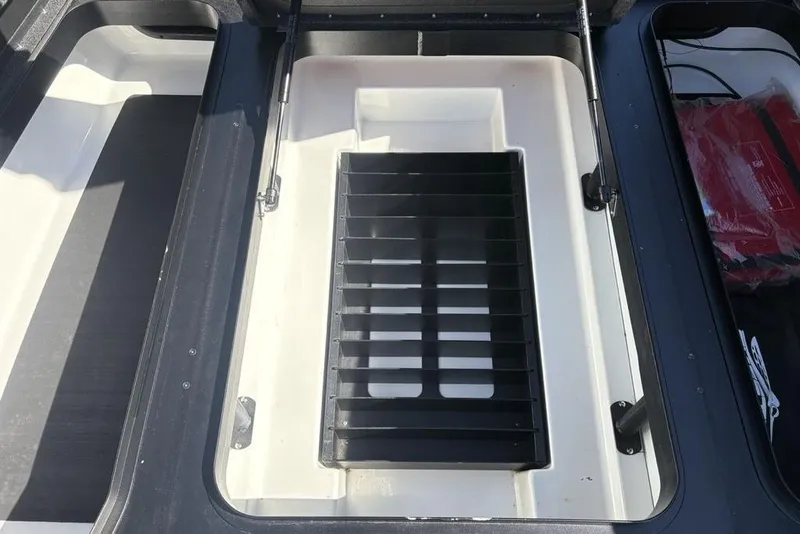 Slide: The Image of 2024 Skeeter ZXR20 boat storage compartment with organized interior layout. - 14