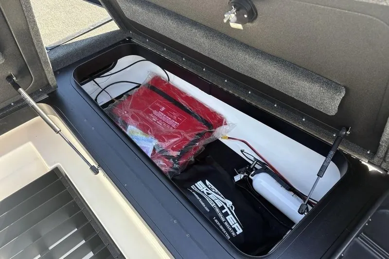 Slide: The Image of Open storage compartment in 2024 Skeeter ZXR20 boat with safety equipment and accessories. - 15