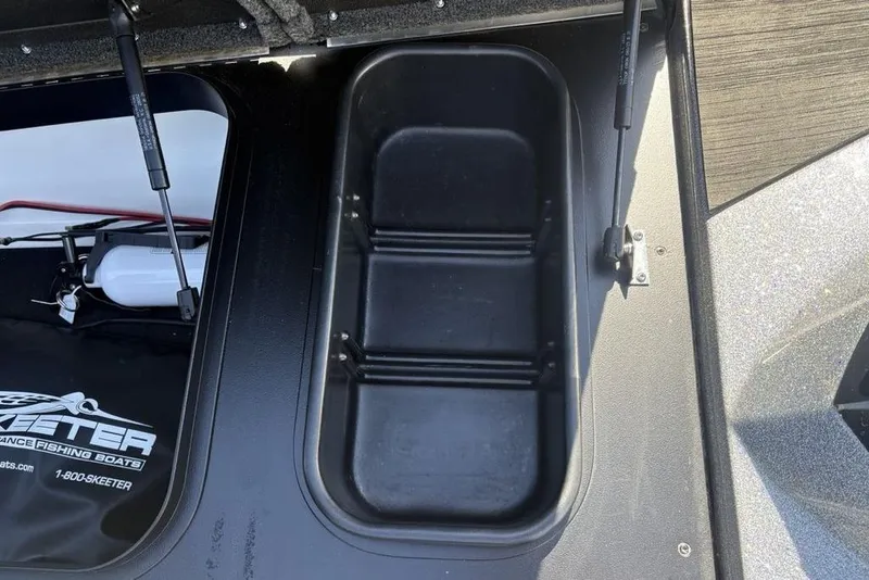 Slide: The Image of 2024 Skeeter ZXR20 boat storage compartment with hydraulic lift supports. - 16
