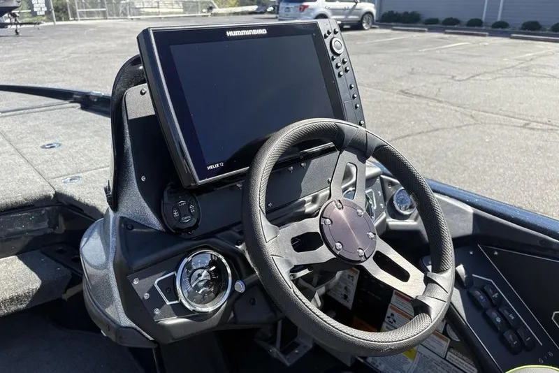 Slide: The Image of 2024 Skeeter ZXR20 boat dashboard with steering wheel and Humminbird Helix 12 display. - 18