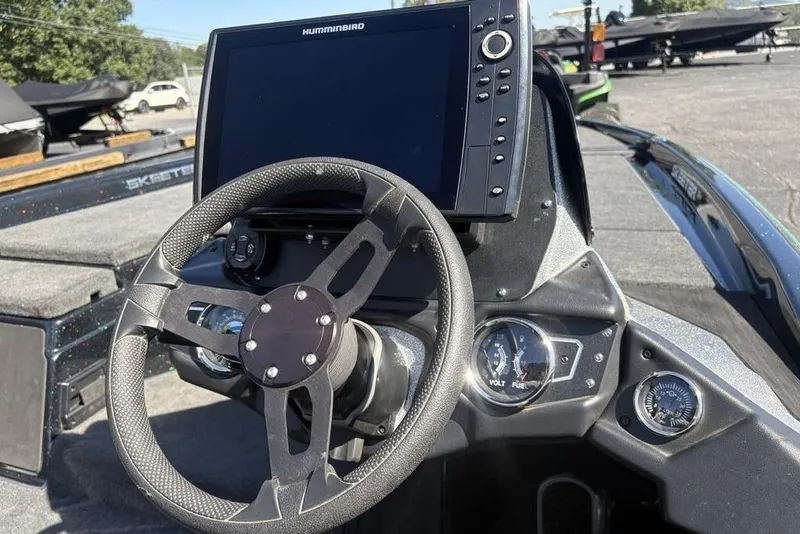 Slide: The Image of 2024 Skeeter ZXR20 boat dashboard with steering wheel and Humminbird display. - 19