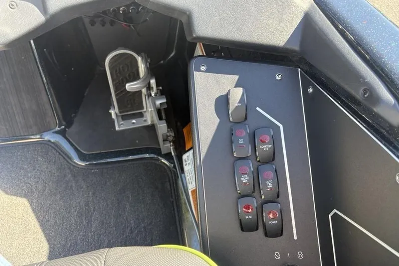 Slide: The Image of 2024 Skeeter ZXR20 boat control panel with foot pedal and switches. - 24