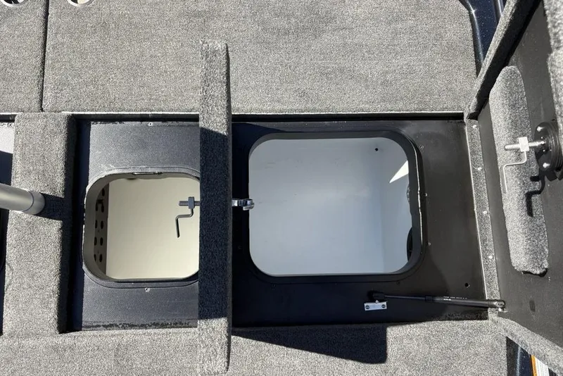 Slide: The Image of 2024 Skeeter ZXR20 boat storage compartments with open hatches, showcasing interior design. - 27