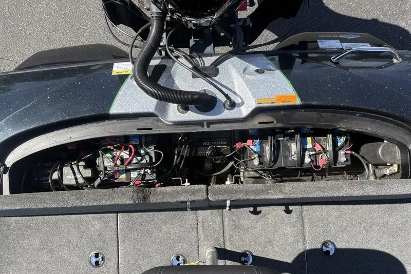 Slide: The Image of 2024 Skeeter ZXR20 boat battery compartment with multiple batteries and wiring. - 32