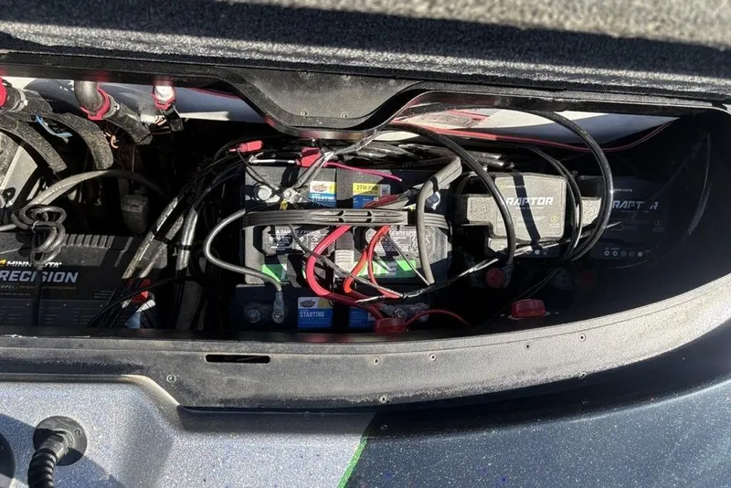 Slide: The Image of 2024 Skeeter ZXR20 boat battery compartment with wiring and chargers. - 33