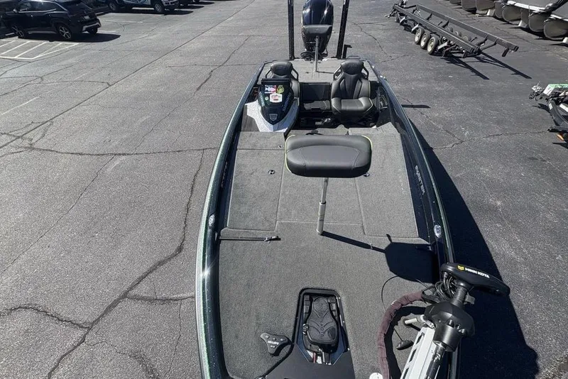 Slide: The Image of 2024 Skeeter ZXR20 fishing boat in parking lot, featuring spacious deck and seating. - 34