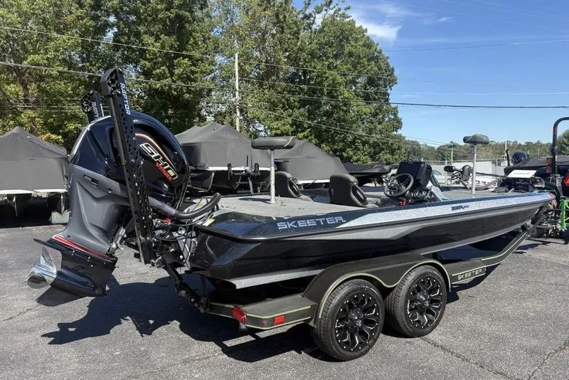 Slide: The Image of 2024 Skeeter ZXR20 boat with powerful outboard motor, parked on a trailer. - 5