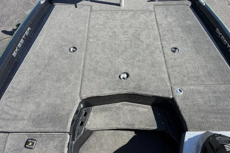 Slide: The Image of 2024 Skeeter ZXR20 boat deck with gray carpet and storage compartments. - 7