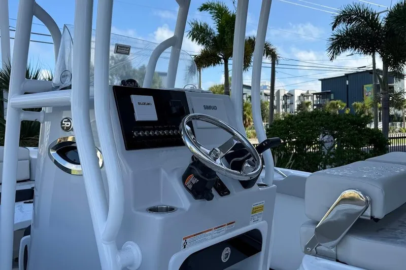 Slide: The Image of 2026 Sea Pro 225FLX Sandbar boat console with steering wheel and controls. - 10
