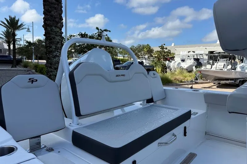 Slide: The Image of 2025 Sea Pro 225FLX Sandbar boat interior with seating and storage, under a clear blue sky. - 4