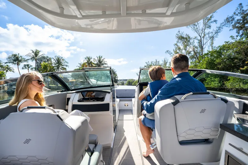 Slide: The Image of 2026 Four Winns H9 OB boat with passengers enjoying a sunny day on the water. - 11