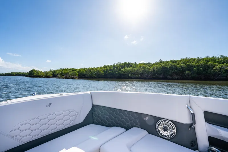 Slide: The Image of 2026 Four Winns H9 OB boat interior with scenic water and lush greenery. - 13