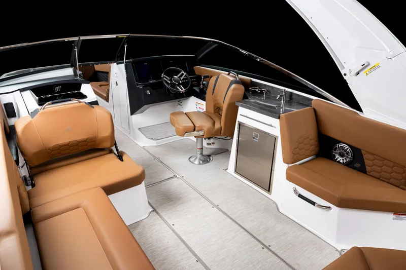 Slide: The Image of Luxurious interior of 2026 Four Winns H9 OB boat with tan seating and modern amenities. - 14