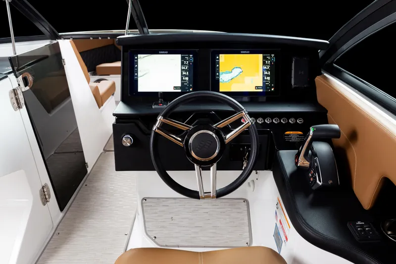 Slide: The Image of 2026 Four Winns H9 OB boat cockpit with modern steering and dual navigation screens. - 15