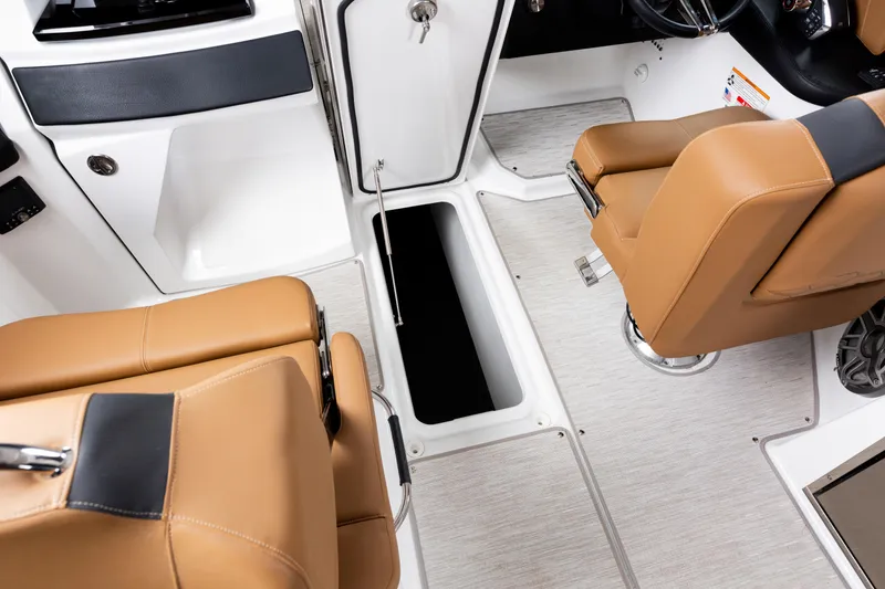 Slide: The Image of 2026 Four Winns H9 OB boat interior with tan seats and storage compartment. - 18