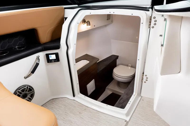 Slide: The Image of 2026 Four Winns H9 OB boat interior with compact bathroom and modern amenities. - 26