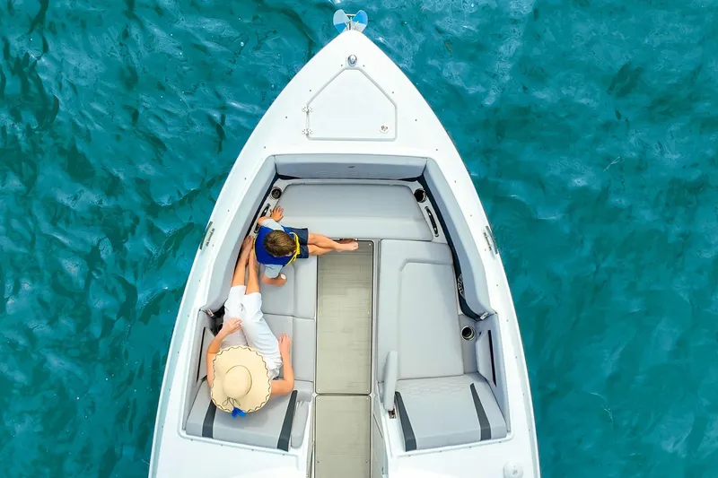 Slide: The Image of Overhead view of 2026 Four Winns H9 OB boat on clear blue water. - 8