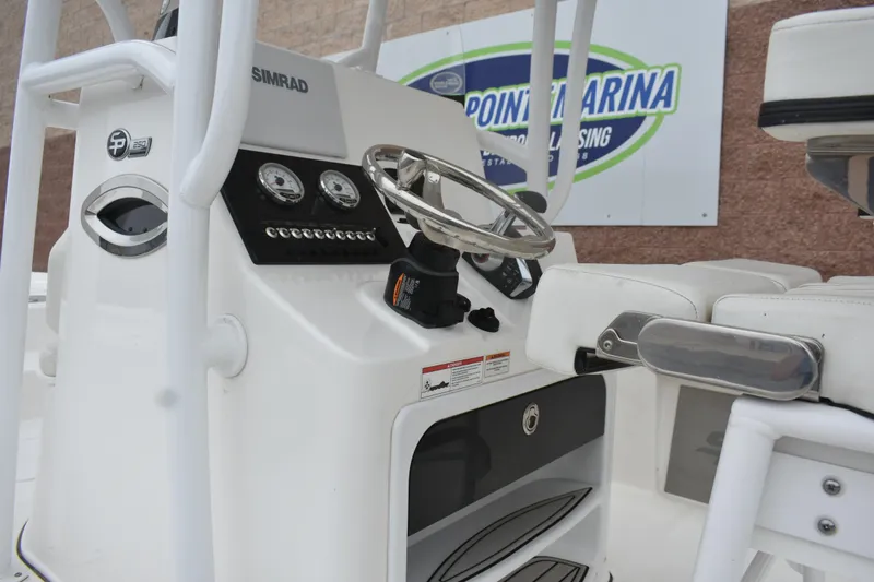 Slide: The Image of 2025 Sea Pro 250 Bay boat console with steering wheel and gauges at Point Marina. - 10