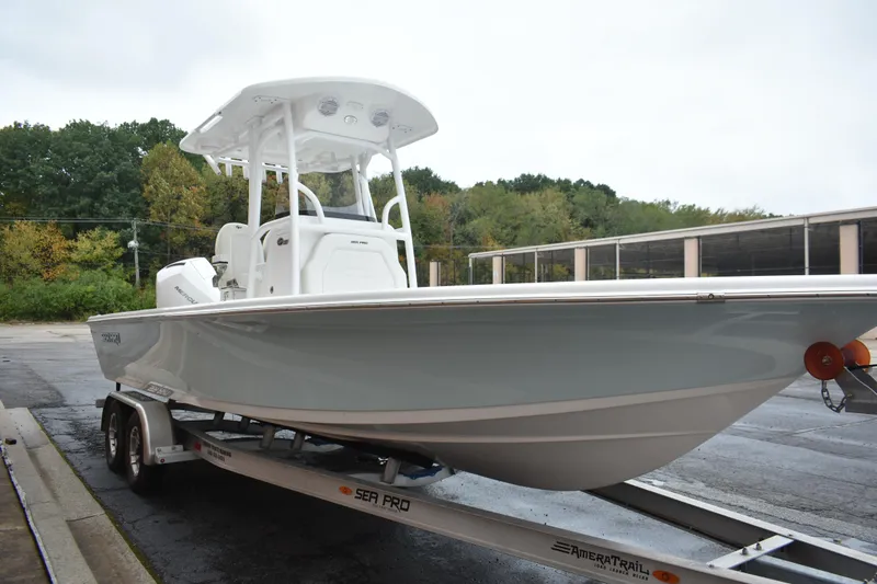 Slide: The Image of 2025 Sea Pro 250 Bay boat on trailer, parked outdoors. - 3