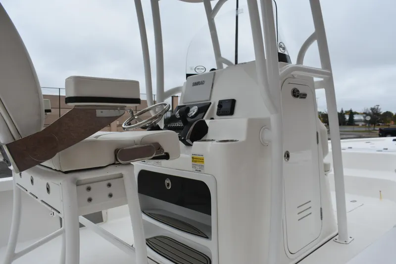 Slide: The Image of 2025 Sea Pro 250 Bay boat interior with steering console and seating. - 5