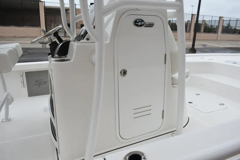 Slide: The Image of 2025 Sea Pro 250 Bay boat console with steering wheel and storage compartment. - 8