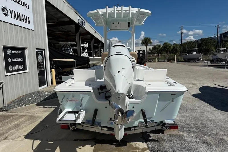 Slide: The Image of 2026 Sea Pro 210 Bay boat with outboard motor at dealership. - 11