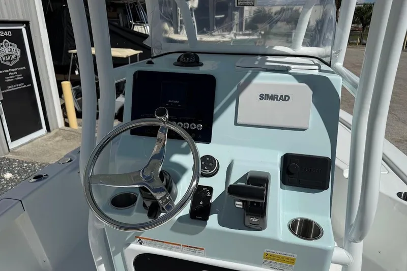 Slide: The Image of 2026 Sea Pro 210 Bay boat console with steering wheel and Simrad electronics. - 14