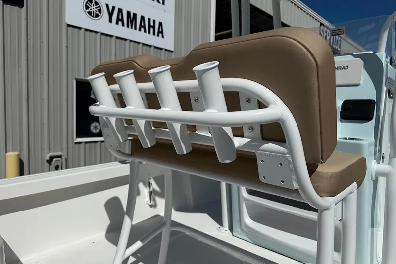 Slide: The Image of 2026 Sea Pro 210 Bay boat with rod holders and cushioned seating. - 16