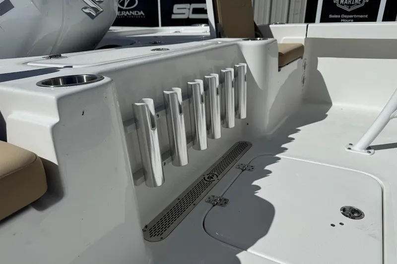 Slide: The Image of 2026 Sea Pro 210 Bay boat interior with rod holders and seating. - 17