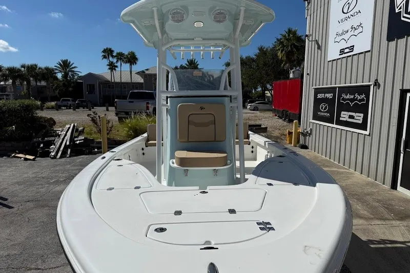 Slide: The Image of 2026 Sea Pro 210 Bay boat docked, featuring spacious deck and center console. - 3