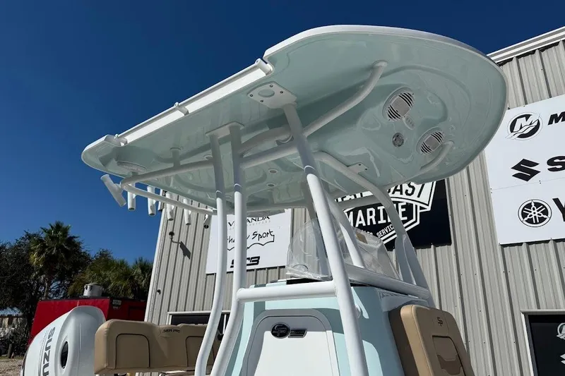 Slide: The Image of 2026 Sea Pro 210 Bay boat with T-top, displayed outdoors against a clear blue sky. - 7