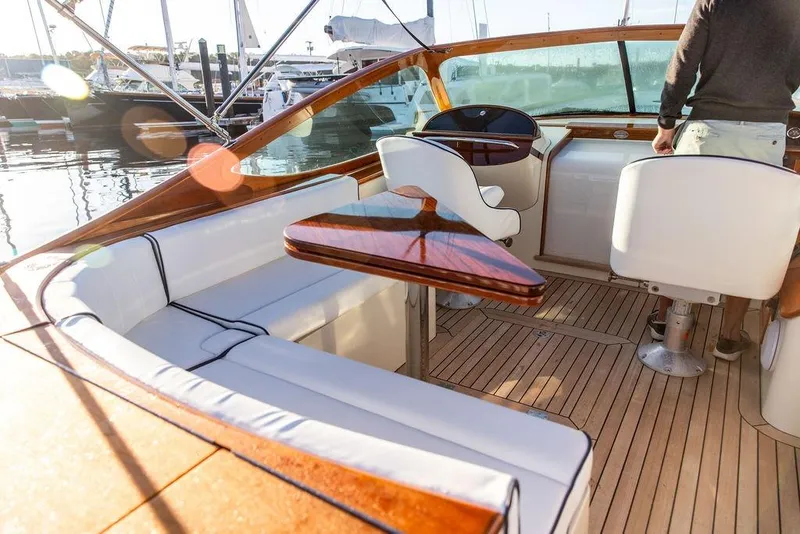 Slide: The Image of Luxurious 2005 Hinckley Talaria 29R yacht interior with elegant seating and wooden accents. - 12
