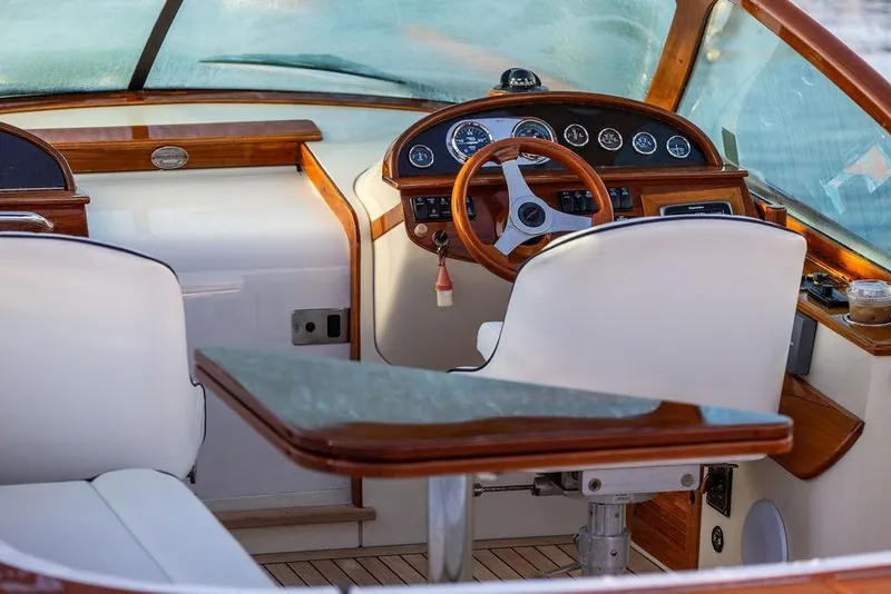Slide: The Image of Interior of a 2005 Hinckley Talaria 29R boat with elegant wood and leather finishes. - 16