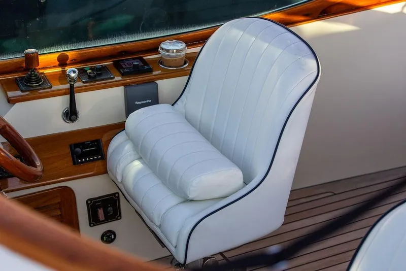 Slide: The Image of Luxury helm seat on 2005 Hinckley Talaria 29R boat with wood accents and controls. - 20