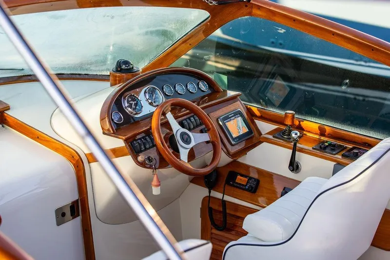 Slide: The Image of 2005 Hinckley Talaria 29R cockpit with wooden dashboard and steering wheel. - 15