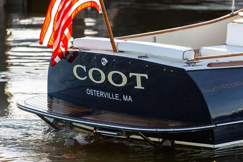 Slide: The Image of 2005 Hinckley Talaria 29R boat named "COOT" in Osterville, MA, with American flag. - 26