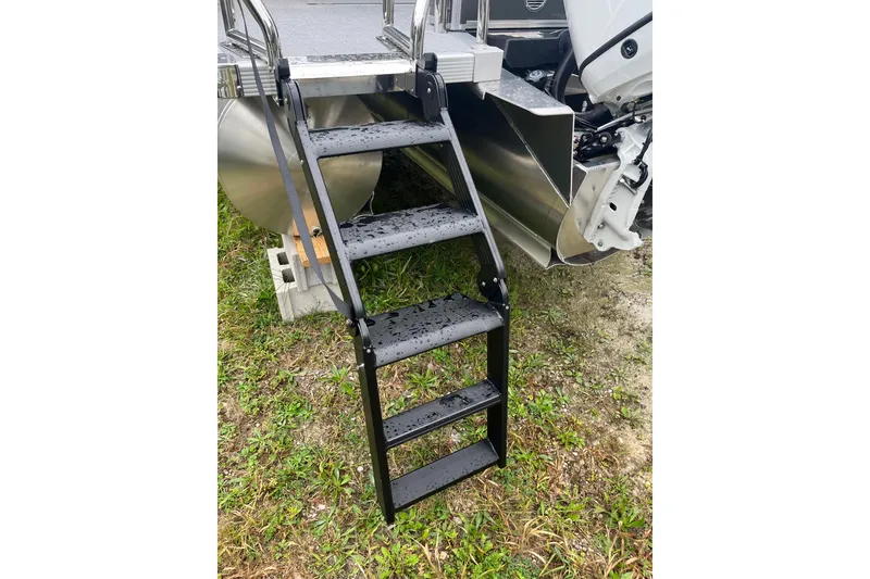 Slide: The Image of 2026 Avalon 25 LSZ ELITE boat ladder on grassy terrain, showcasing sturdy design. - 11