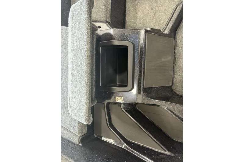 Slide: The Image of 2026 Skeeter ZXE20 interior compartment with carpeted cover and storage space. - 15