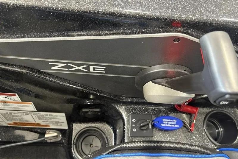 Slide: The Image of 2026 Skeeter ZXE20 boat control panel with throttle and ignition switch. - 23