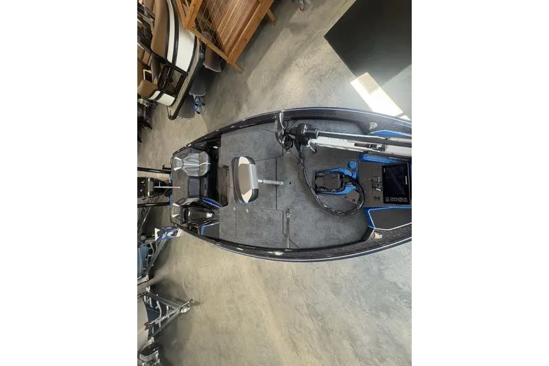 Slide: The Image of 2026 Skeeter ZXE20 boat interior with seating and equipment, displayed in a showroom. - 24