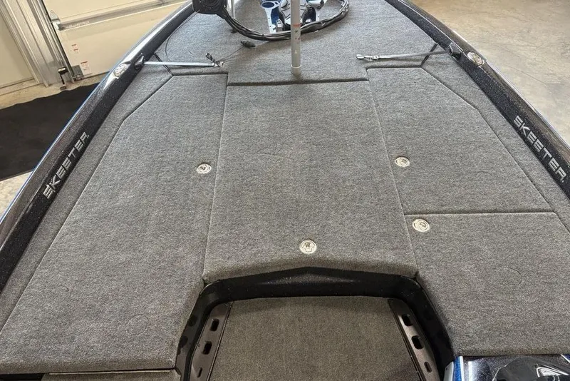 Slide: The Image of 2026 Skeeter ZXE20 boat deck with gray carpet and storage compartments. - 5