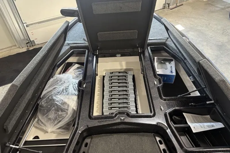 Slide: The Image of 2026 Skeeter ZXE20 boat storage compartments with organized tackle boxes and accessories. - 8