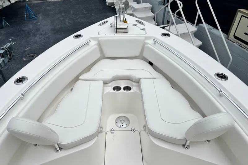 Slide: The Image of 2026 Key West 239 FS boat interior with white cushioned seating and cup holders. - 11