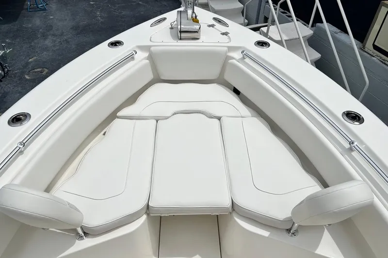 Slide: The Image of 2026 Key West 239 FS boat with white cushioned seating and stainless steel railings. - 12