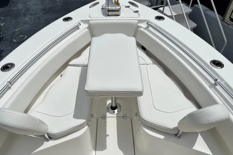 Slide: The Image of 2026 Key West 239 FS boat interior with white cushioned seating and table. - 13