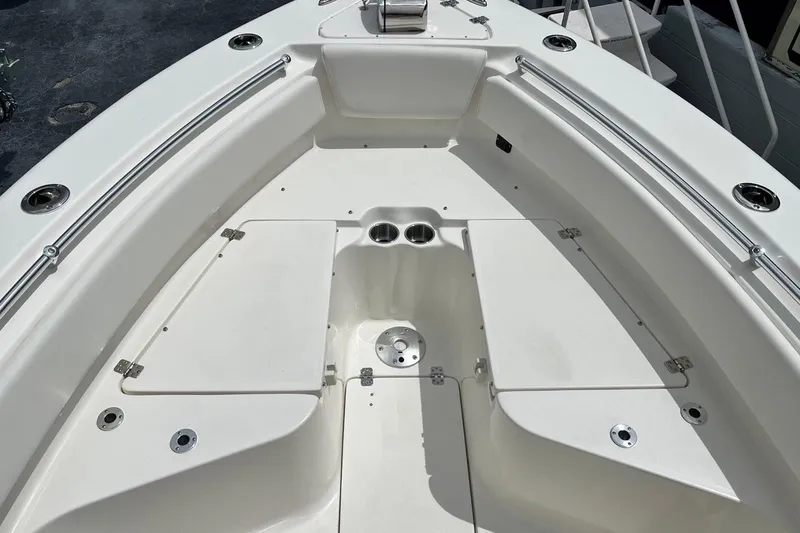 Slide: The Image of 2026 Key West 239 FS boat interior with storage compartments and cup holders. - 14