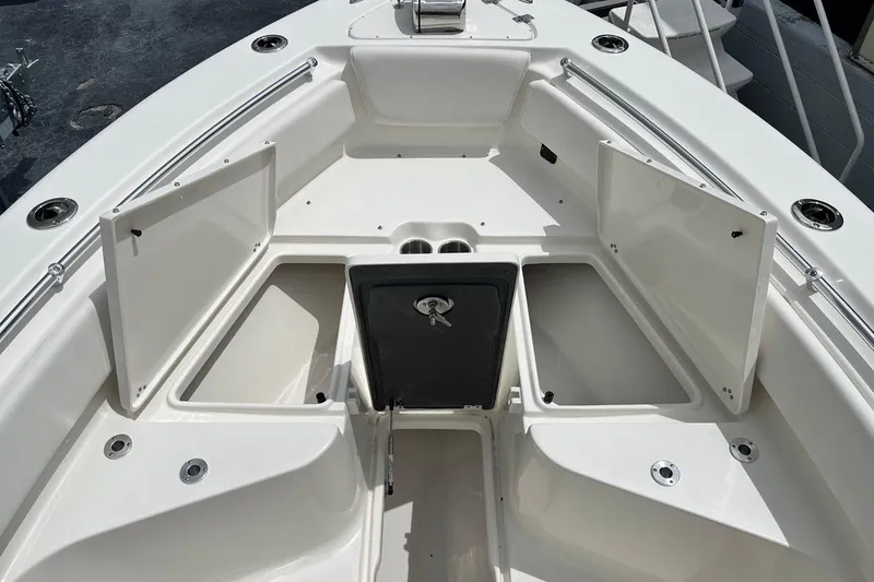 Slide: The Image of 2026 Key West 239 FS boat with open storage compartments on deck. - 15