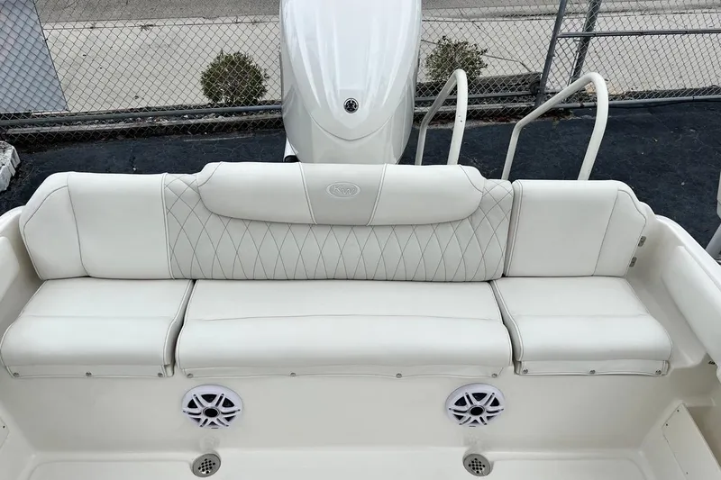 Slide: The Image of 2026 Key West 239 FS boat with white cushioned seating and speakers. - 16