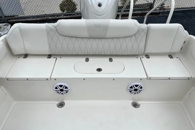 Slide: The Image of 2026 Key West 239 FS boat interior with white cushioned seating and built-in speakers. - 17