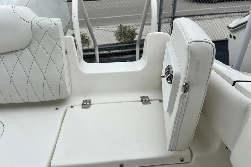 Slide: The Image of 2026 Key West 239 FS boat seat with white upholstery and storage compartment. - 19